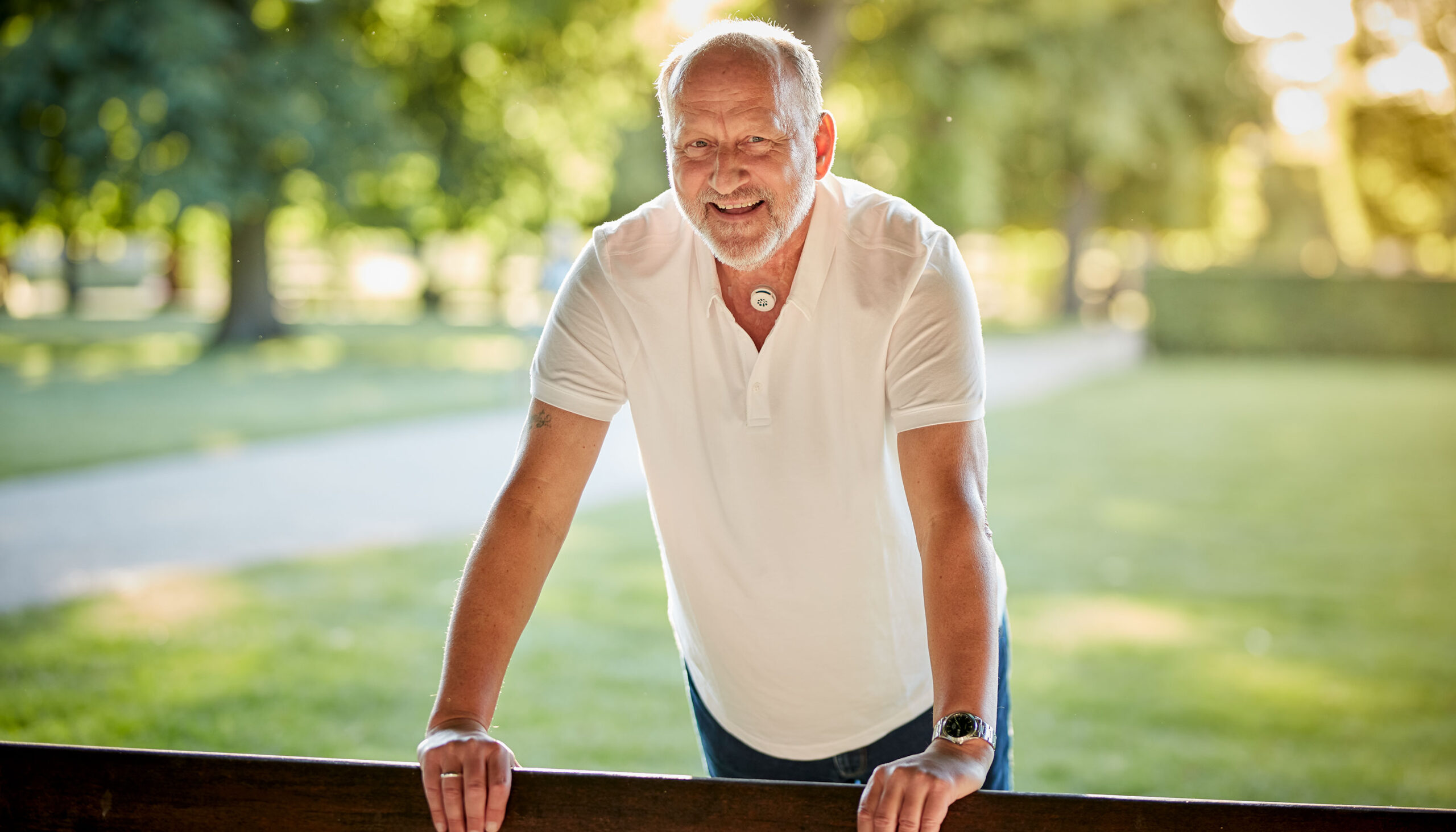 Man with a neck stoma using Provox life energy HME outdoors.